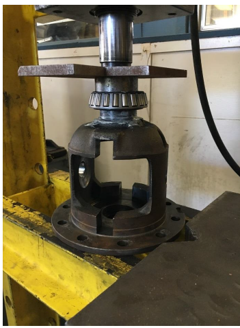 Figure 52. The hydraulic press with a small concentric tube to apply pressure to the inner race of the bearing without interfering with the differential.